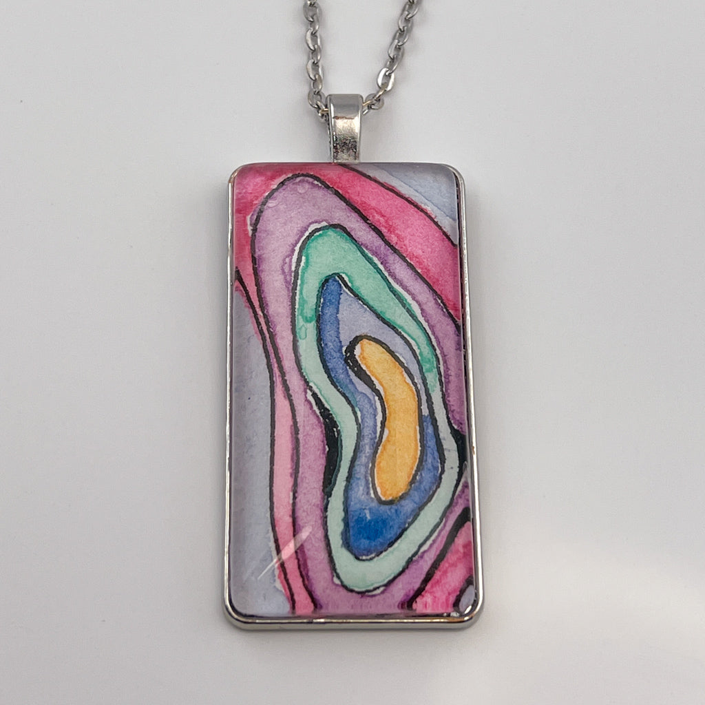 Hand-painted watercolor topographical map set behind a rectangular glass cabochon. 
