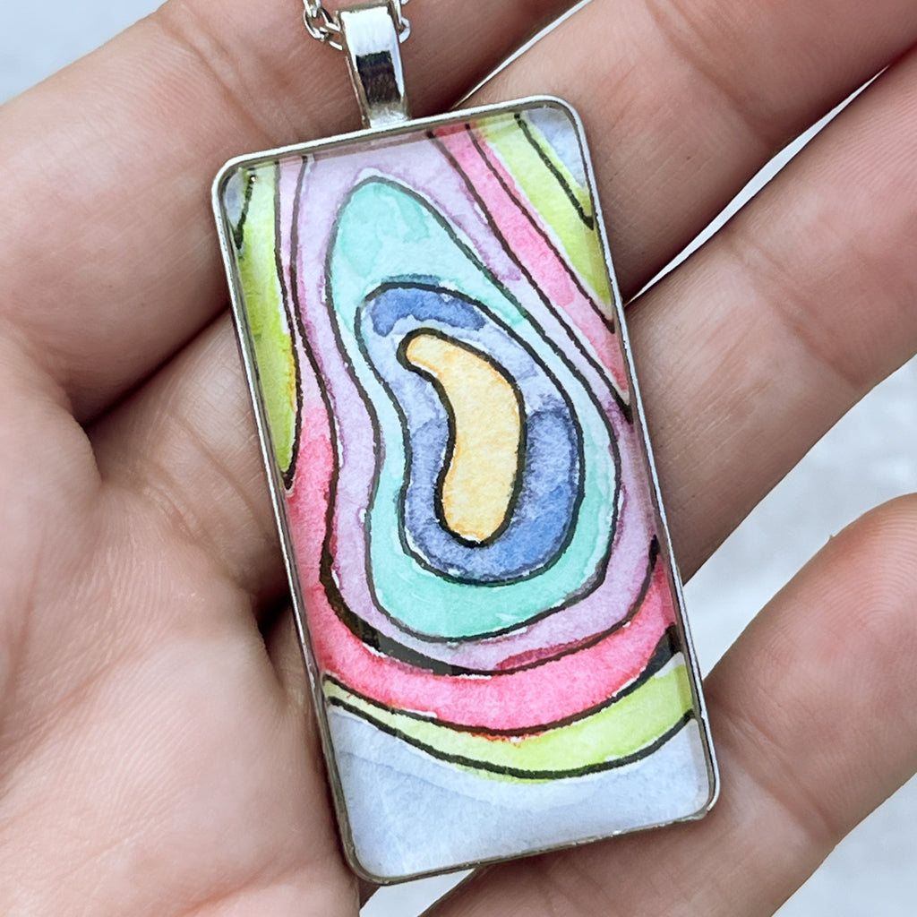 Elevation pendant shown held in hand. 