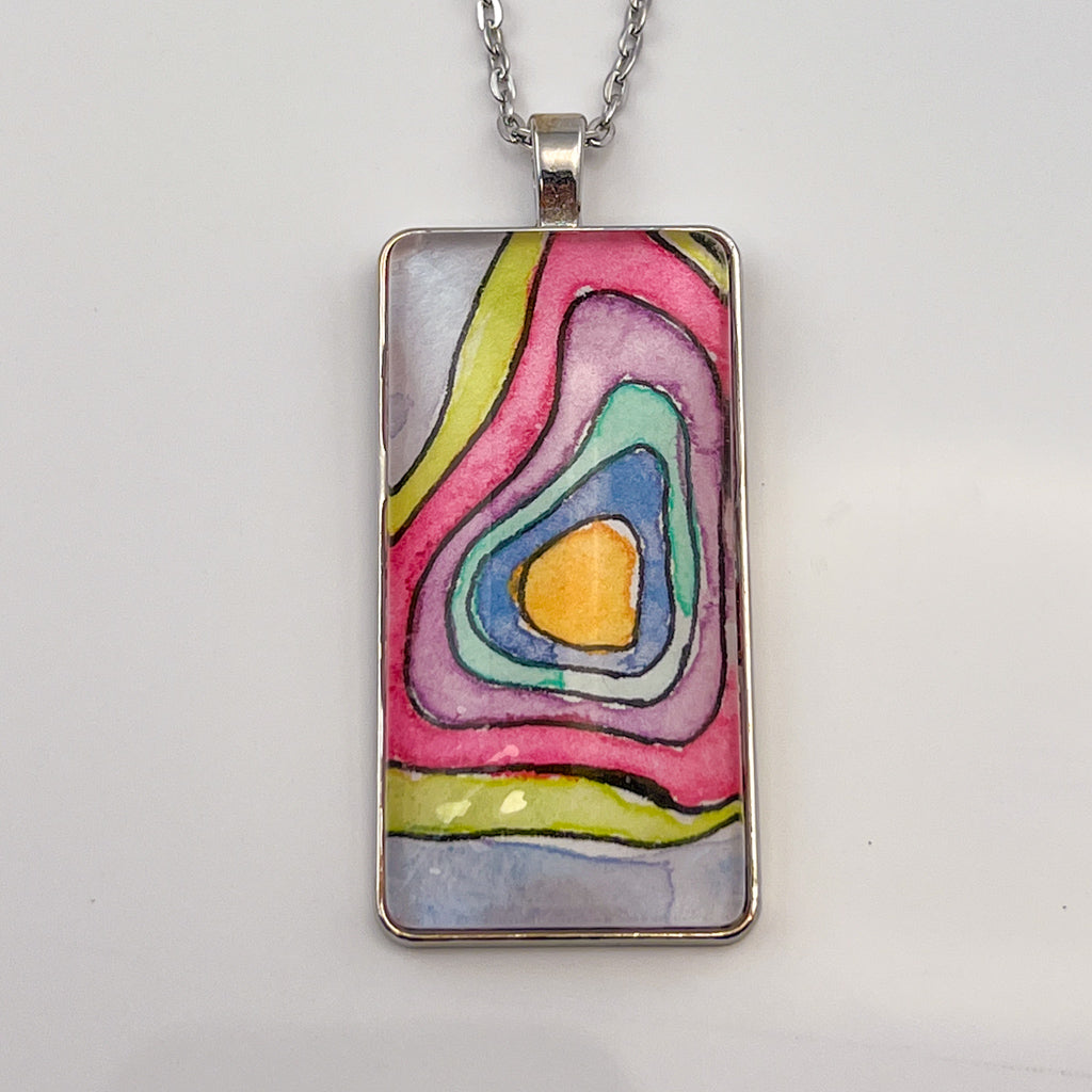Hand-painted watercolor topographical map set behind a rectangular glass cabochon. 