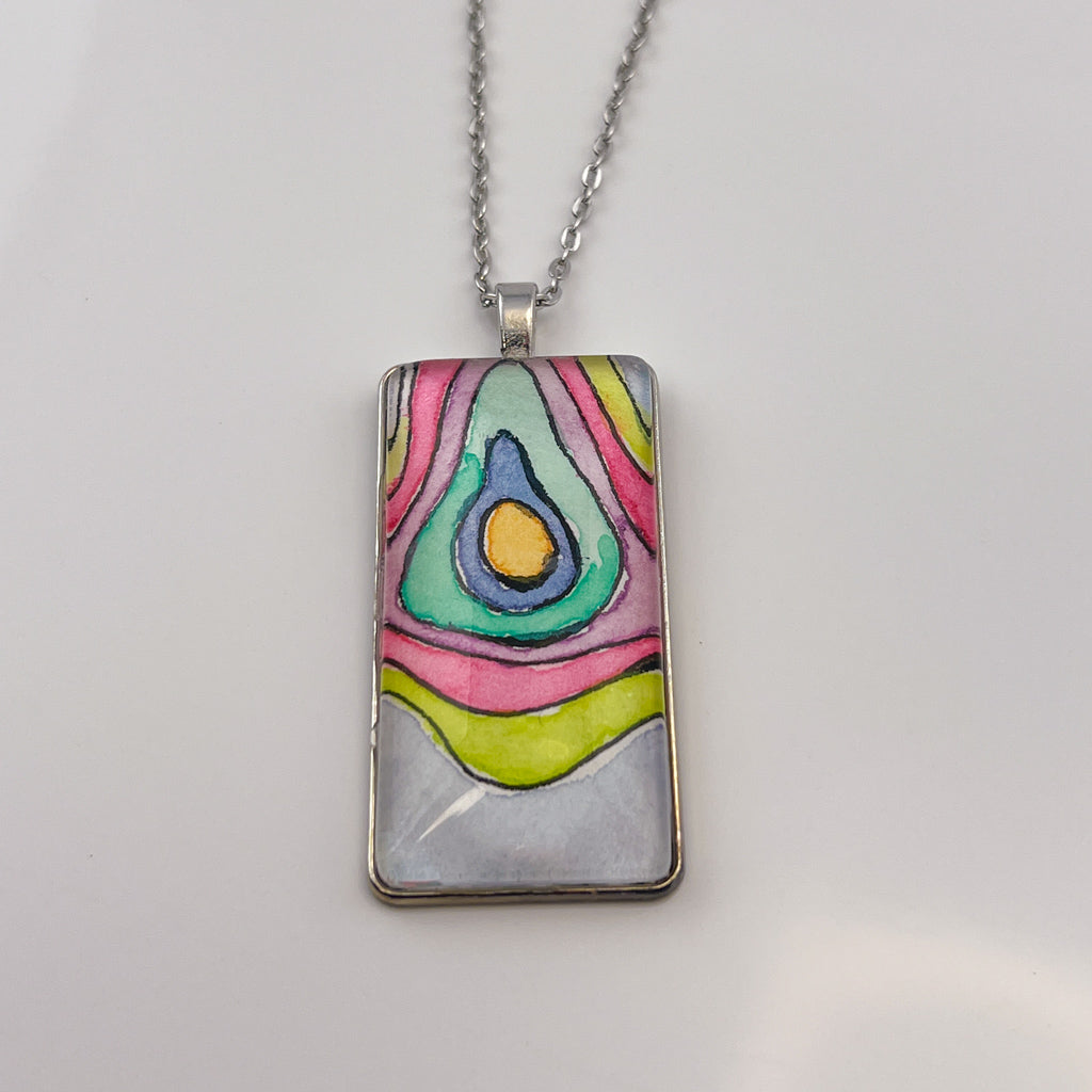 Hand-painted watercolor topographical map set behind a rectangular glass cabochon. 