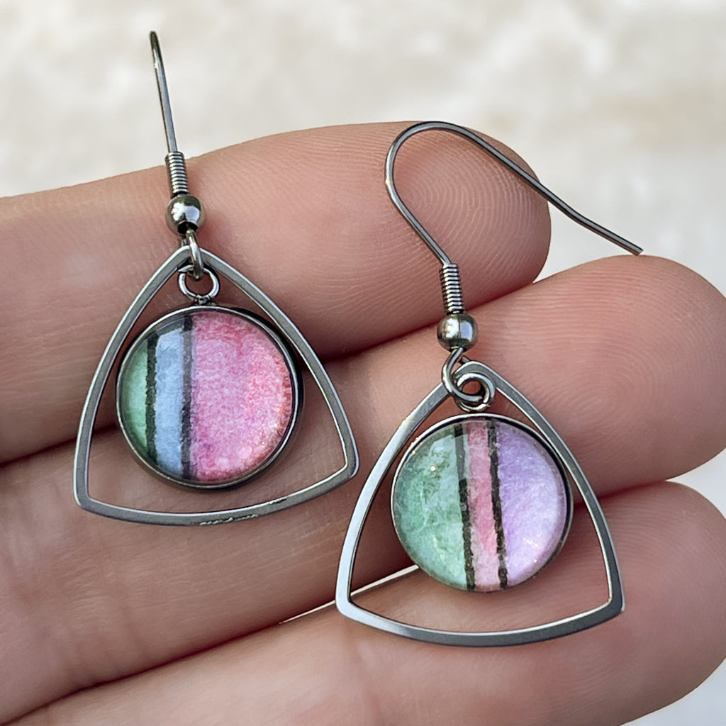 Pink, green, blue and purple pastel watercolor earrings with a triangular frame. 