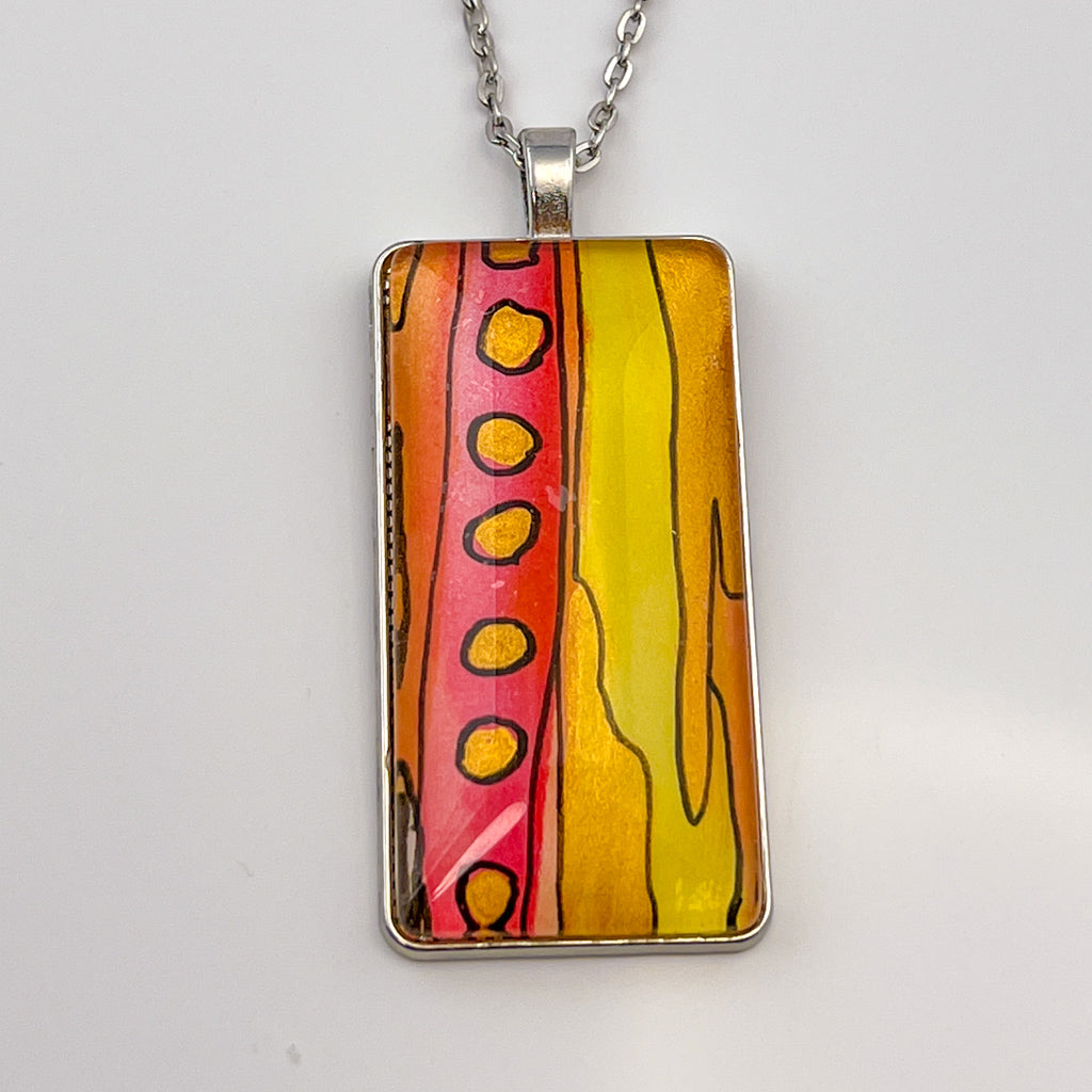 Wide rectangular watercolor pendant with a hand-painted watercolor design in hot pink, yellow and gold. 