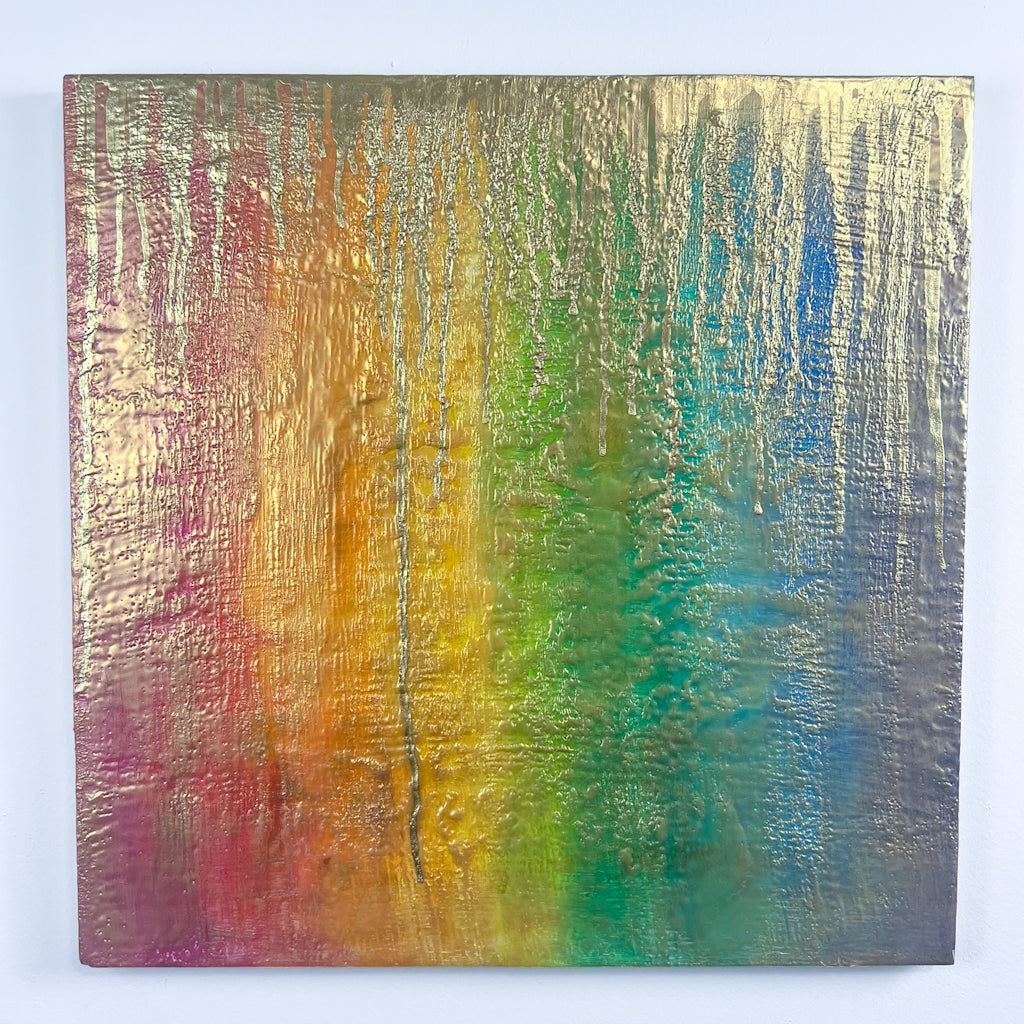 Rainbow-huedencaustic painting, lightly gilded with gold sheen, with drips of deeper gold raining down from the top edge of the work. 