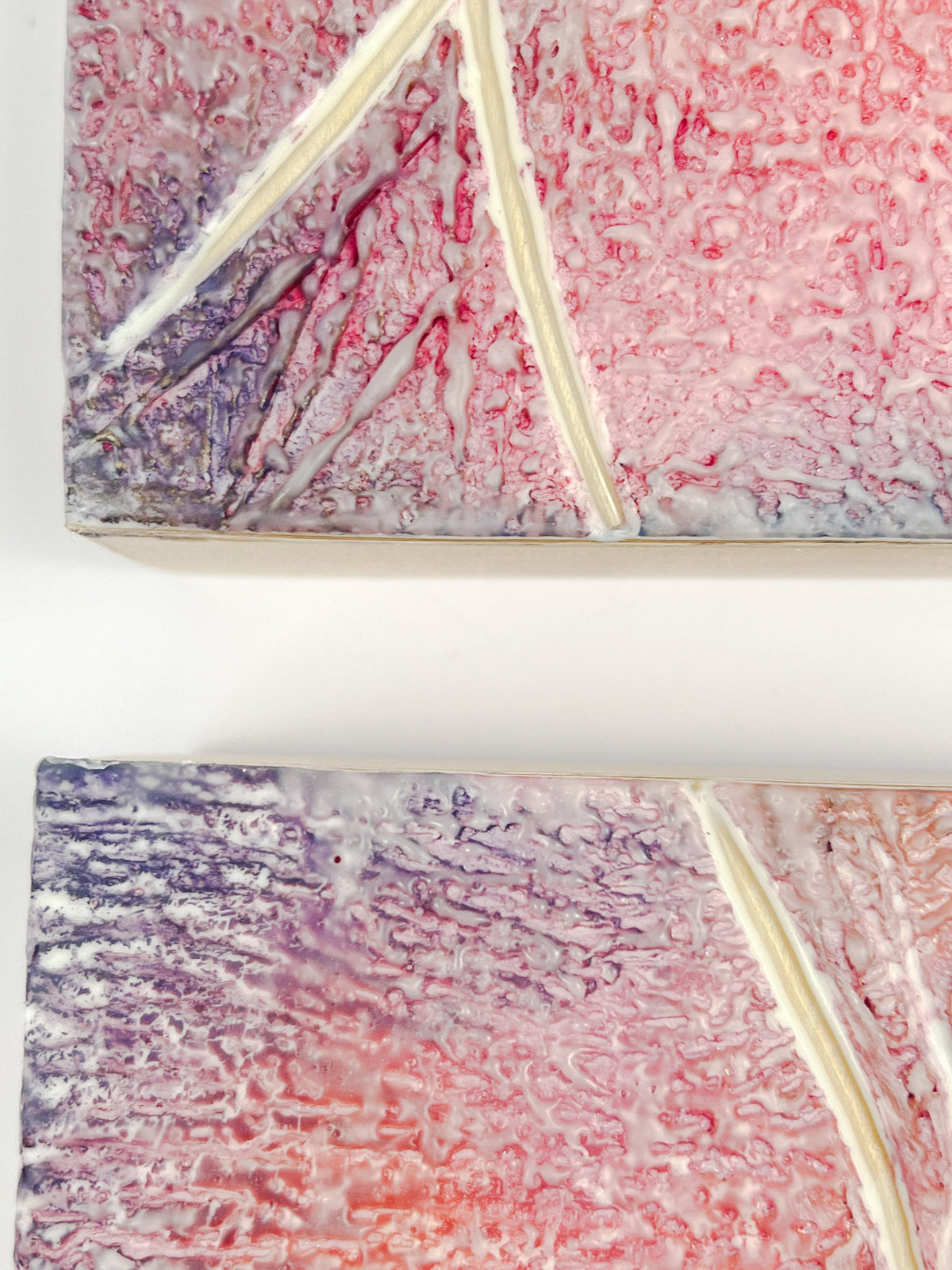 Close up of showing the detail of two pink and purple textured encaustic paintings measuring 4&quot; x 4&quot;