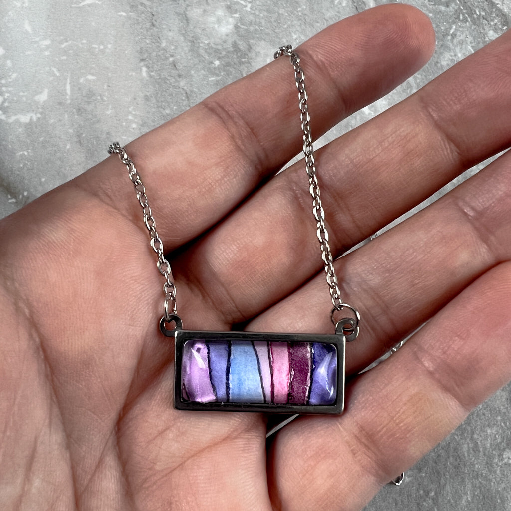 Horizontal rectangle necklace featuring wavy purple stripes in watercolor.