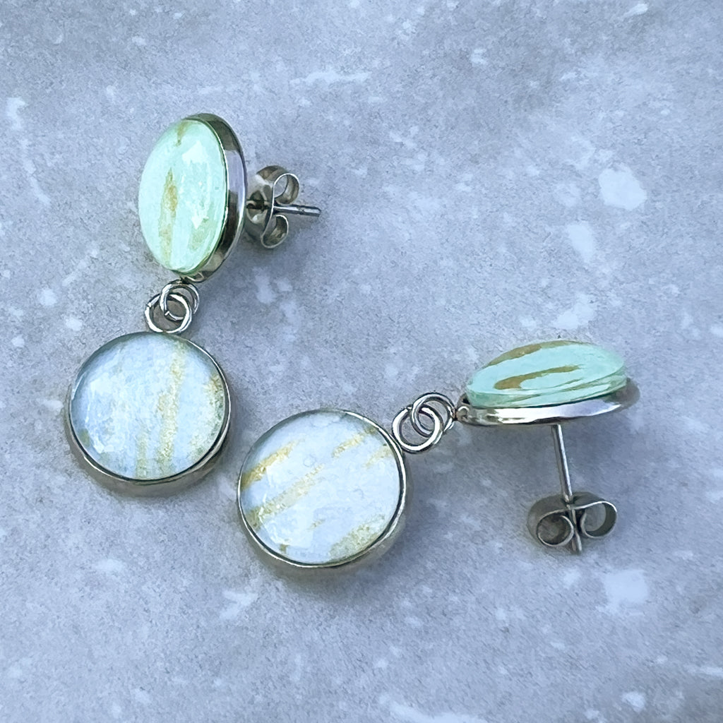 Phobe earrings showing the pale blue and green watercolor art streaked with gold mica. 
