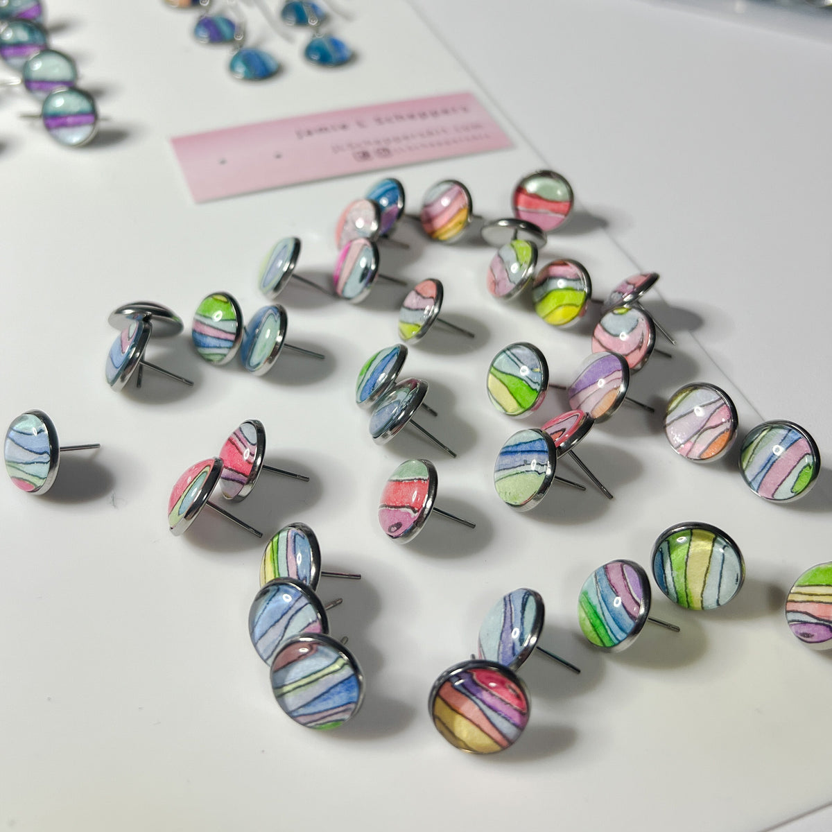 Pile of watercolor rainbow studs. 