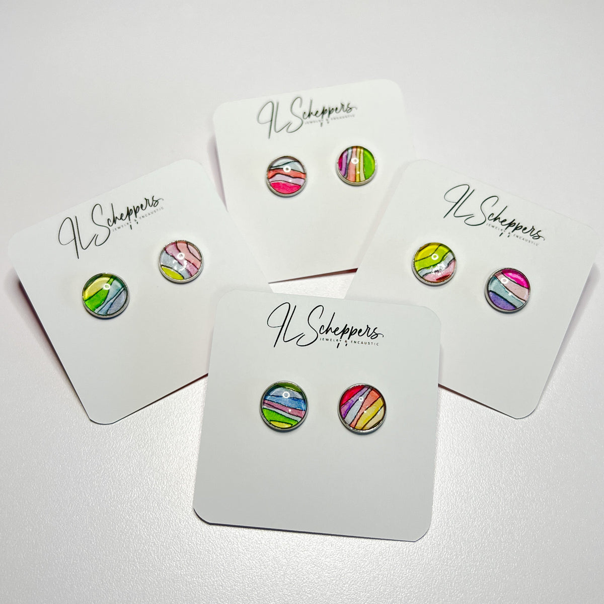 Samples of the watercolor designs found in the surprise rainbow studs. 