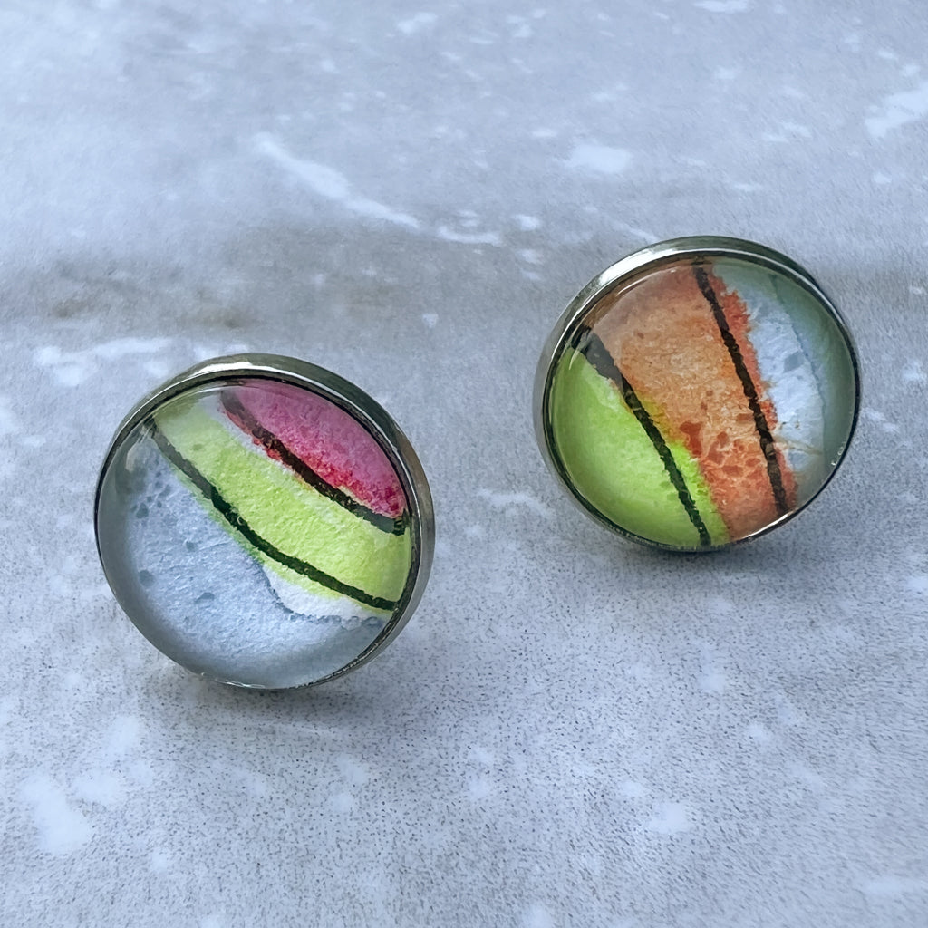 Closeup of rainbow studs showing the hand-painted watercolor and ink detail. 