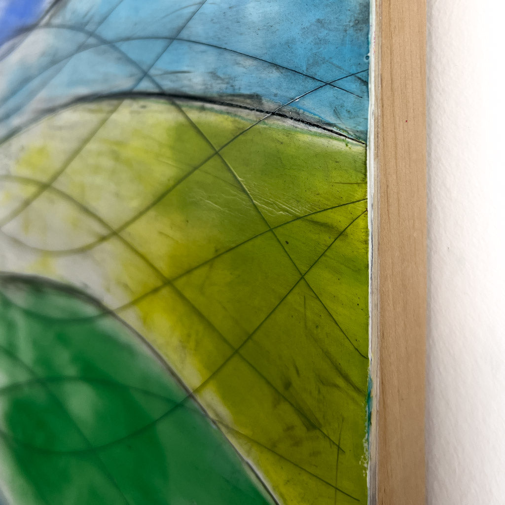 Close up of the edge of the cradled panel, showing the edge detail of a green and blue section of the painting. 