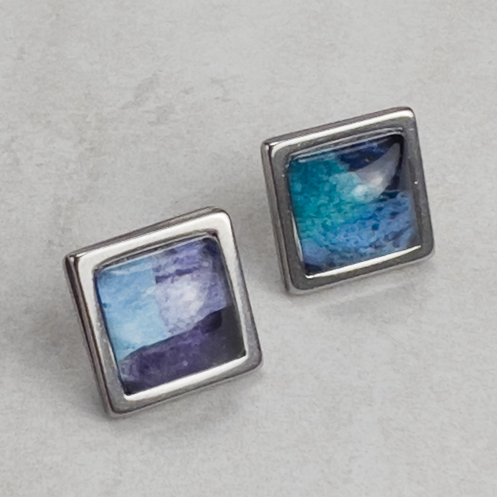 Square stud earrings with Blue Superfly art.