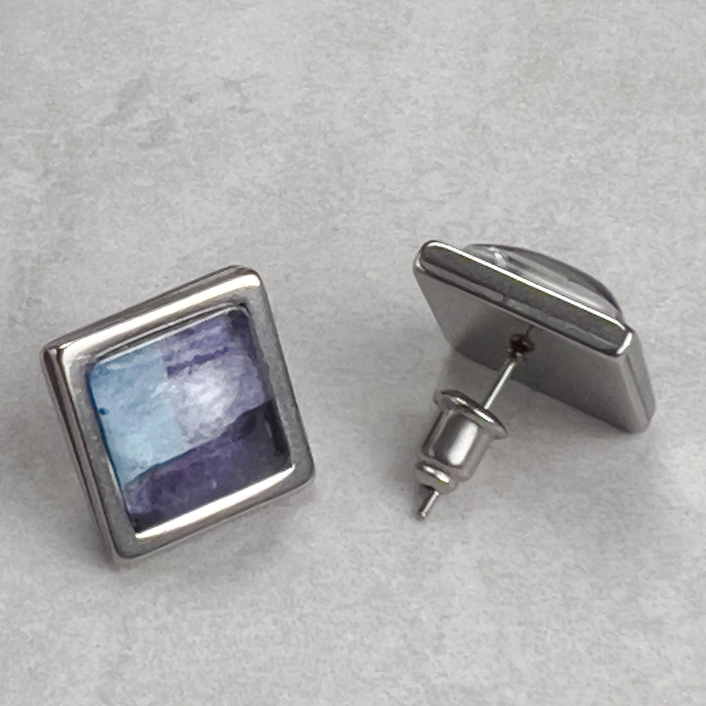 Square stud earrings with Blue Superfly art.