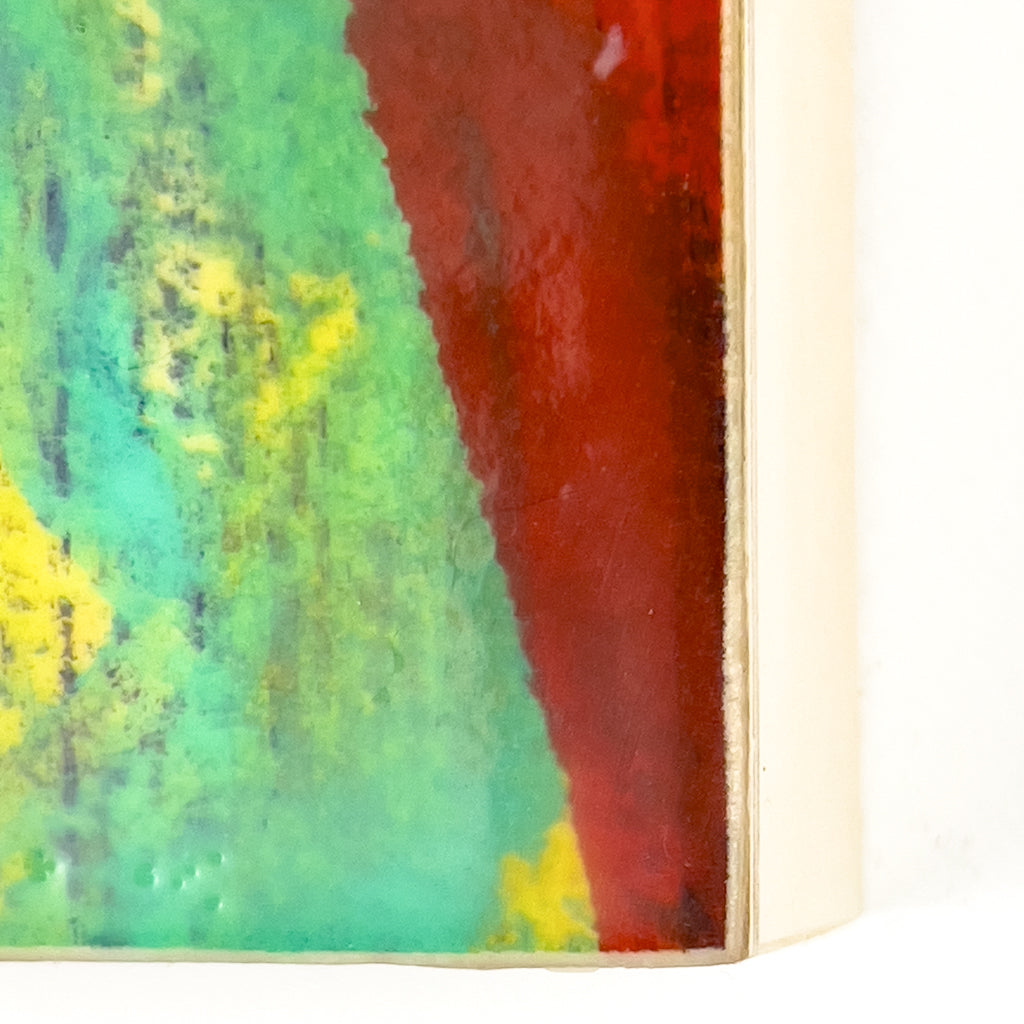 Front view of watercolor and encaustic painting, featuring layered shades of red, green, yellow and purple. 
