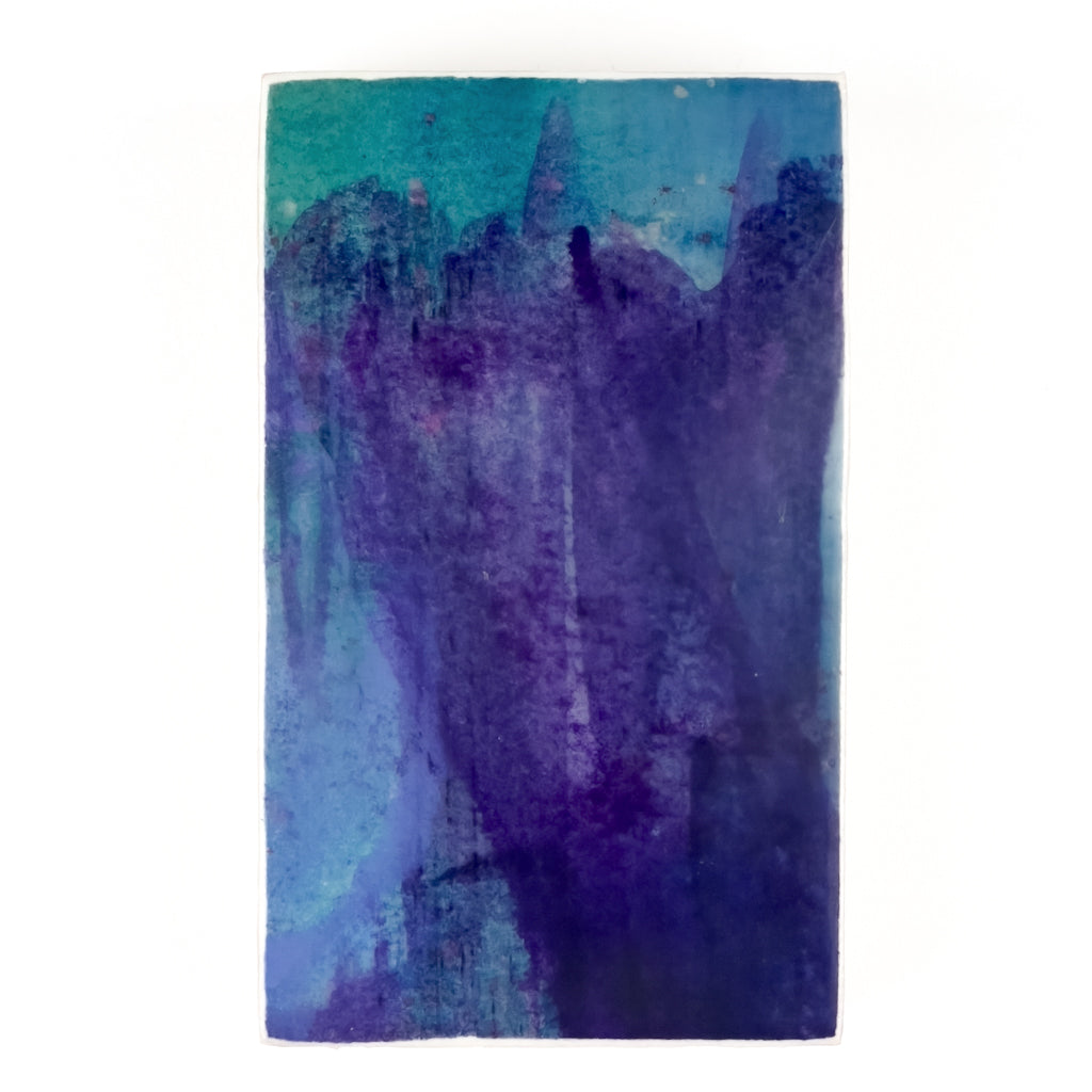 Front view of watercolor and encaustic painting, featuring layered shades of blue, purple and teal. 