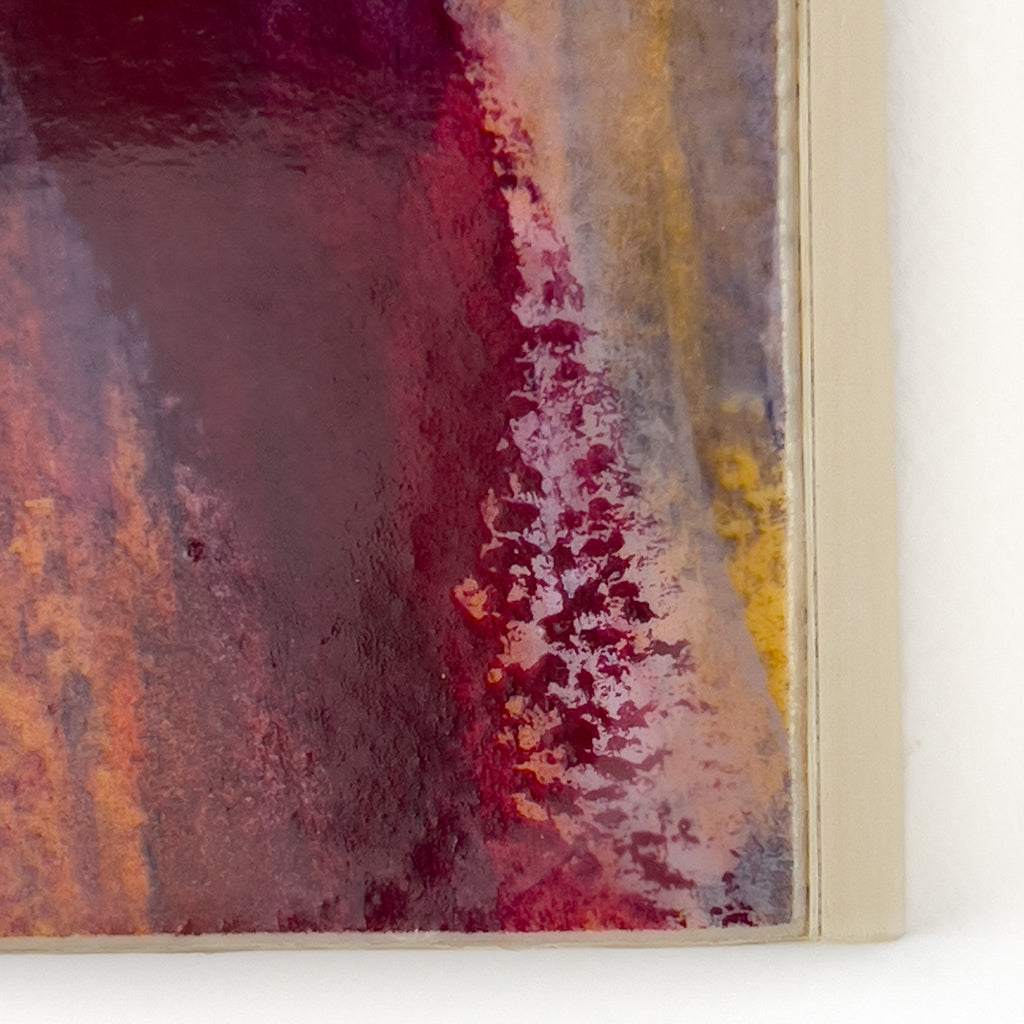 Front view of watercolor and encaustic painting, featuring layered shades of red and orange. 