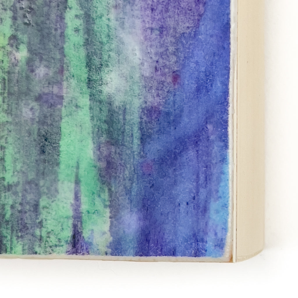 Front view of watercolor and encaustic painting, featuring layered shades of blues and greens.