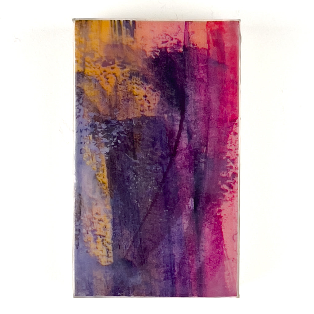Front view of watercolor and encaustic painting, featuring layered shades of  pinks, purples and orange. 