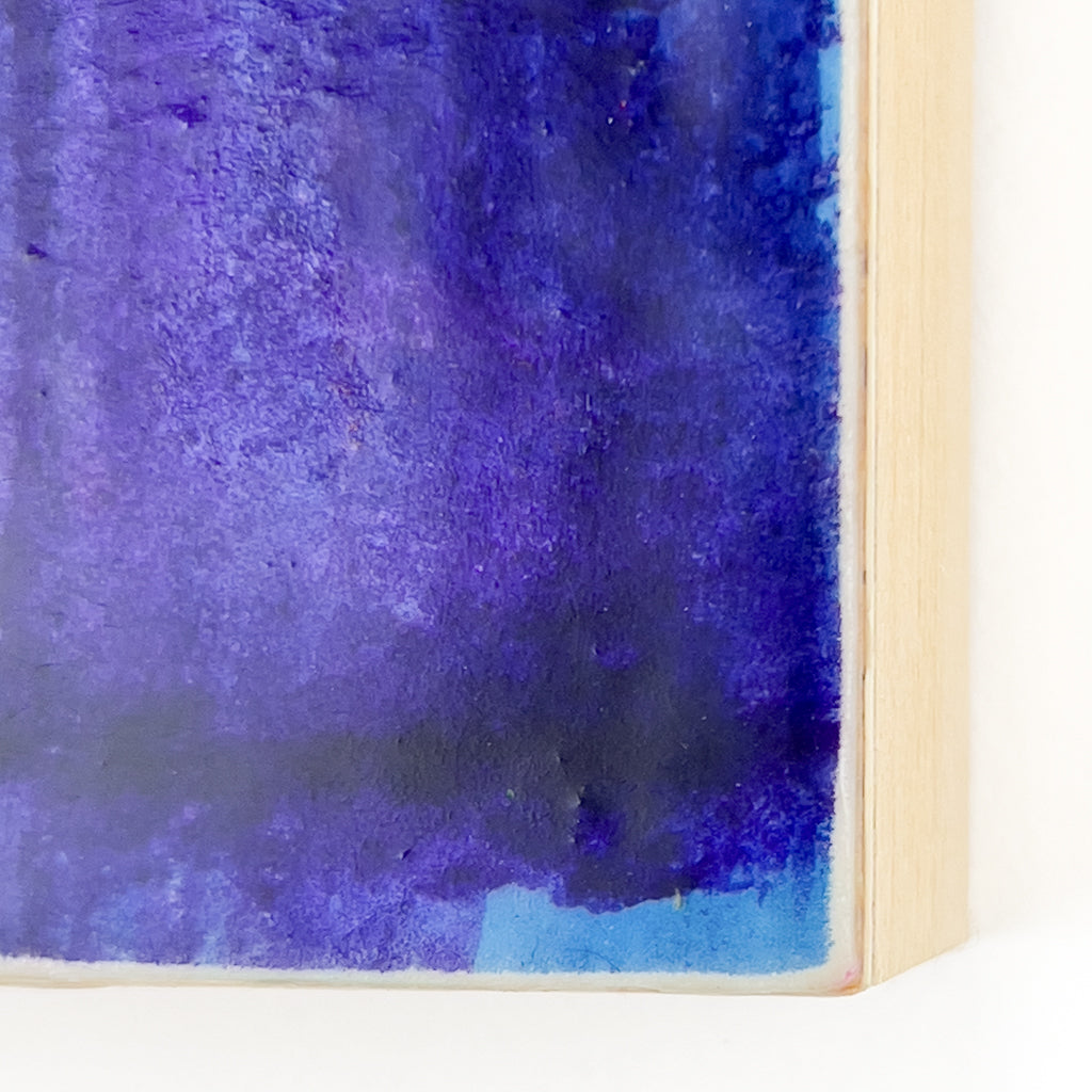Front view of watercolor and encaustic painting, featuring layered shades of blue and purple. 