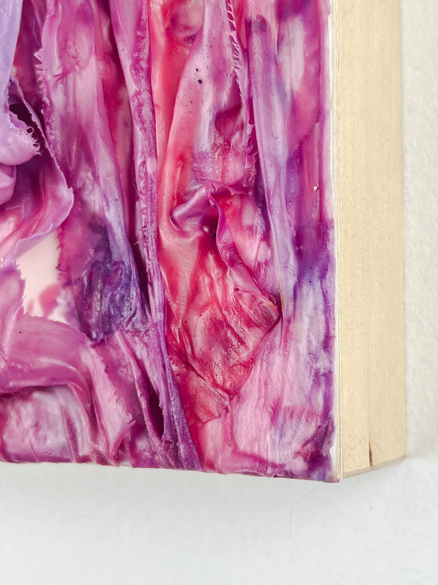 6-inch square encaustic and fiber art featuring ribbons dipped in pink and purple wax and draped.