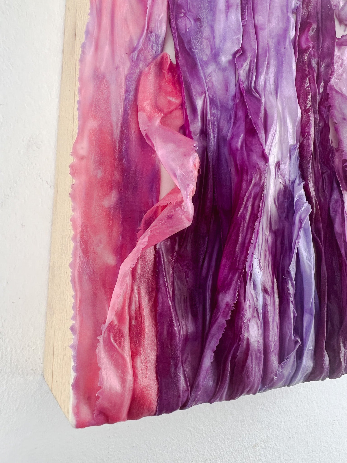Close up of encaustic and ribbon painting showing the edge of the cradled birch board.