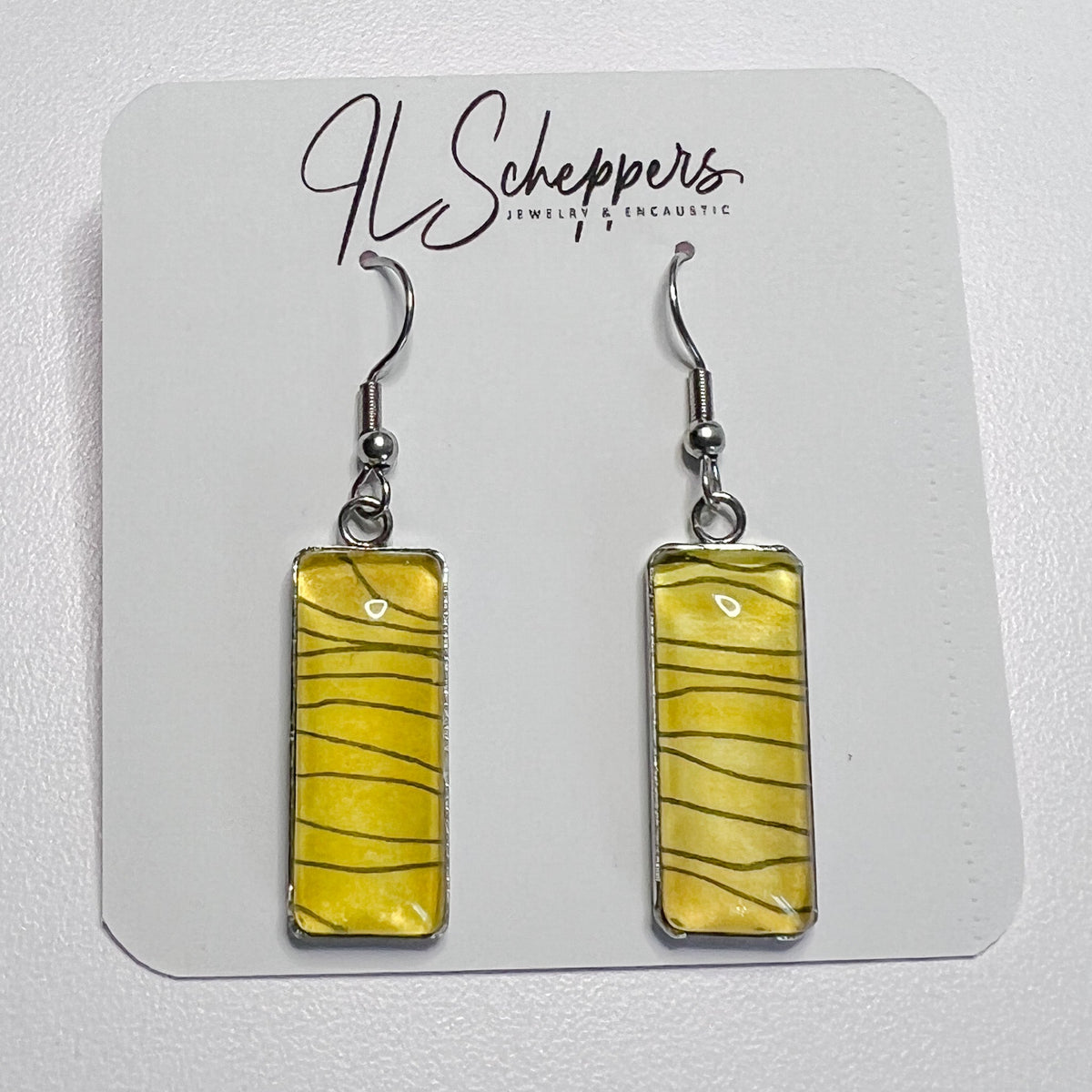 Hand-painted black and gold earrings with wavy black lines on a gold watercolor background. 