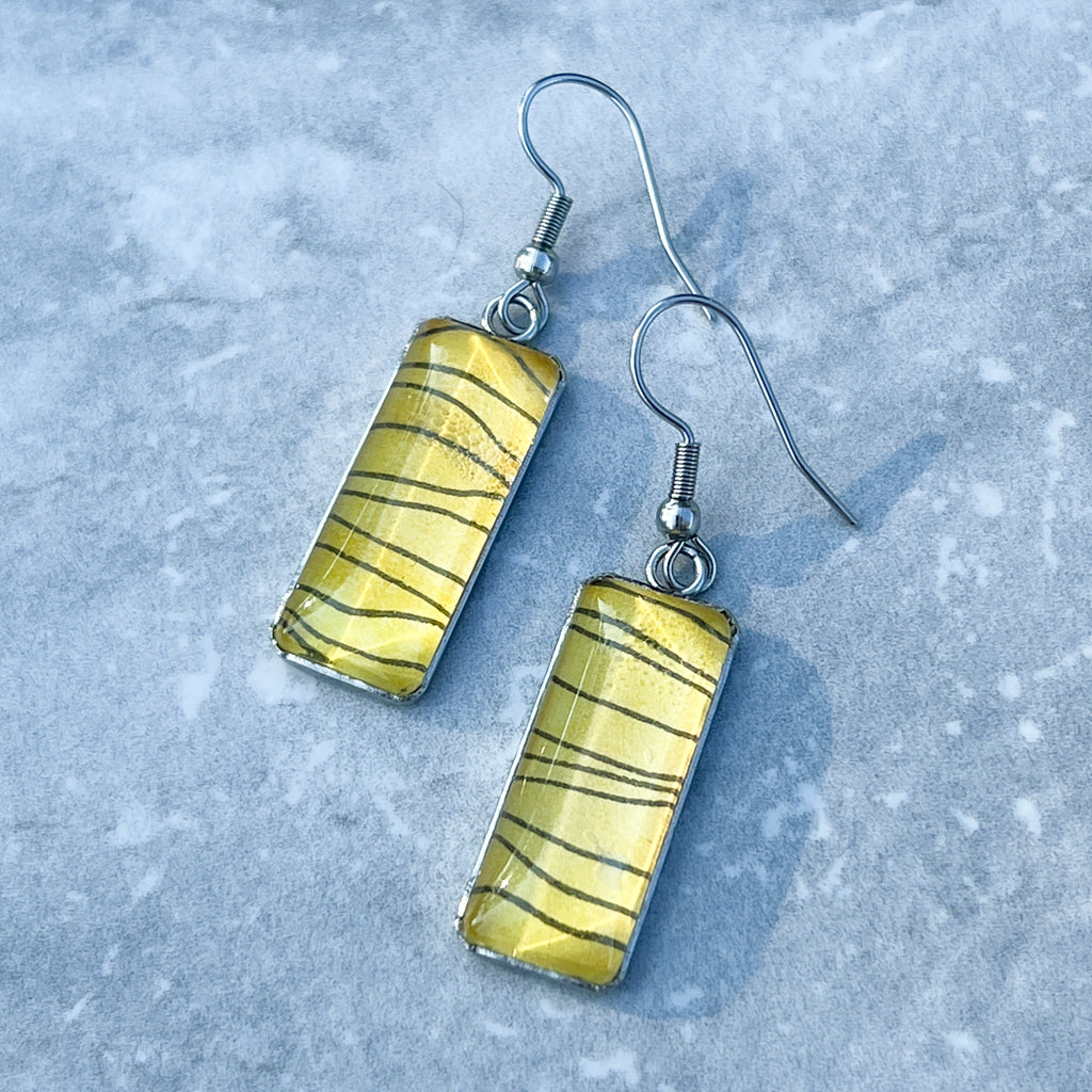 Tiger Stripe rectangular Vertical Drop earrings on grey background. 