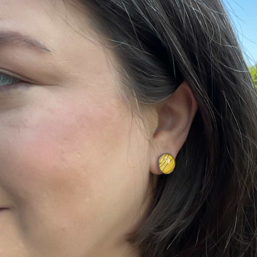 Tiger Stripe stud earrings on grey background.
