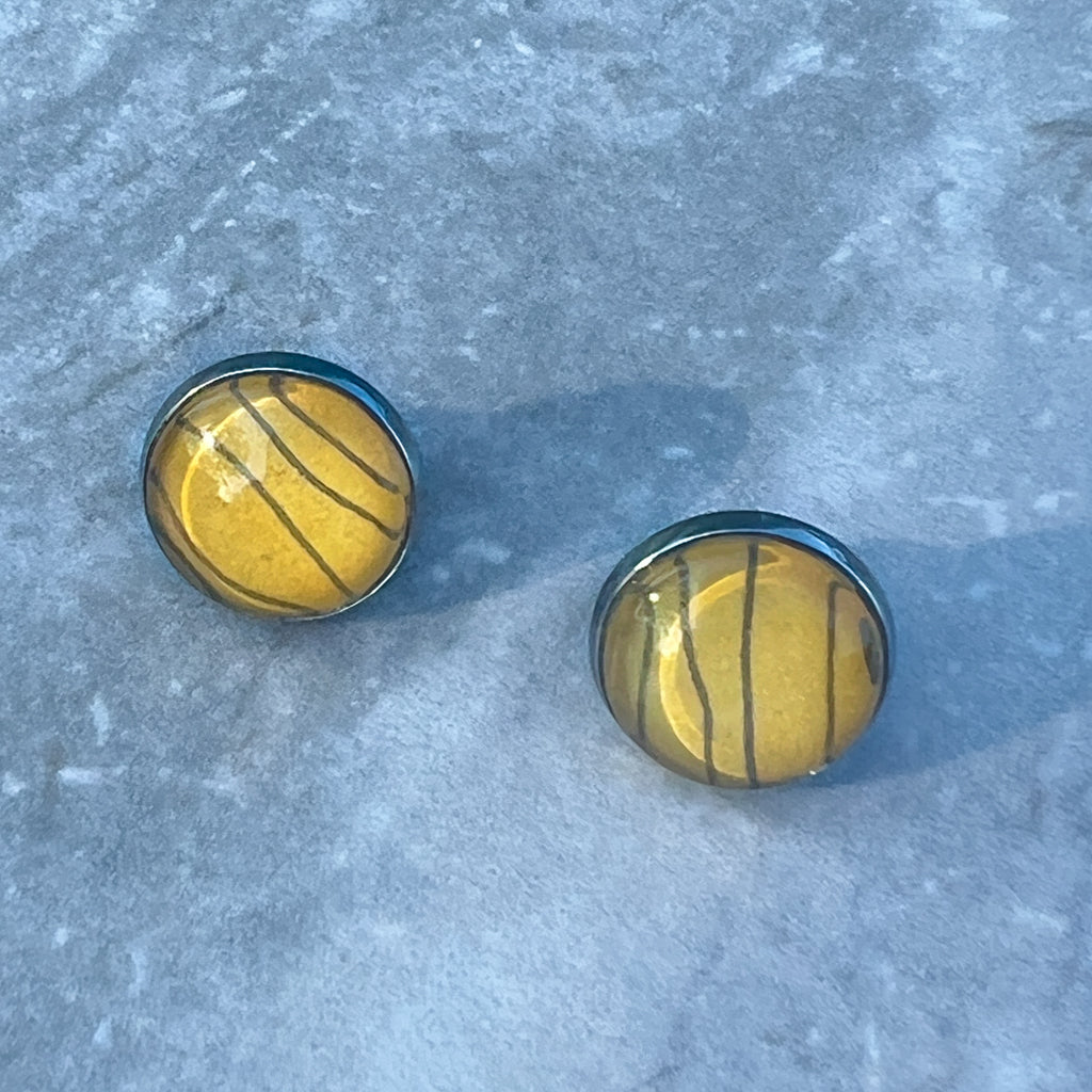 Tiger Stripe stud earrings on grey background.