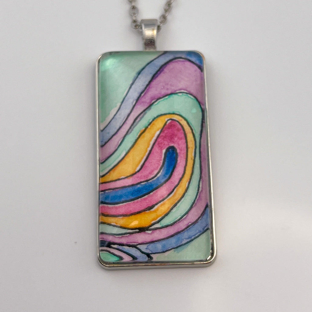 Hand-painted watercolor topographical map set behind a rectangular glass cabochon. 