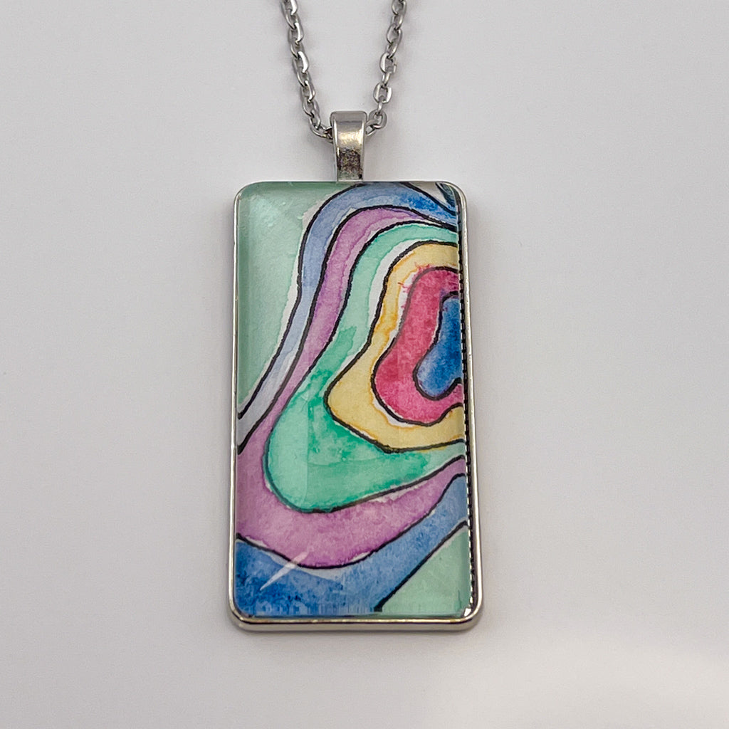 Hand-painted watercolor topographical map set behind a rectangular glass cabochon. 