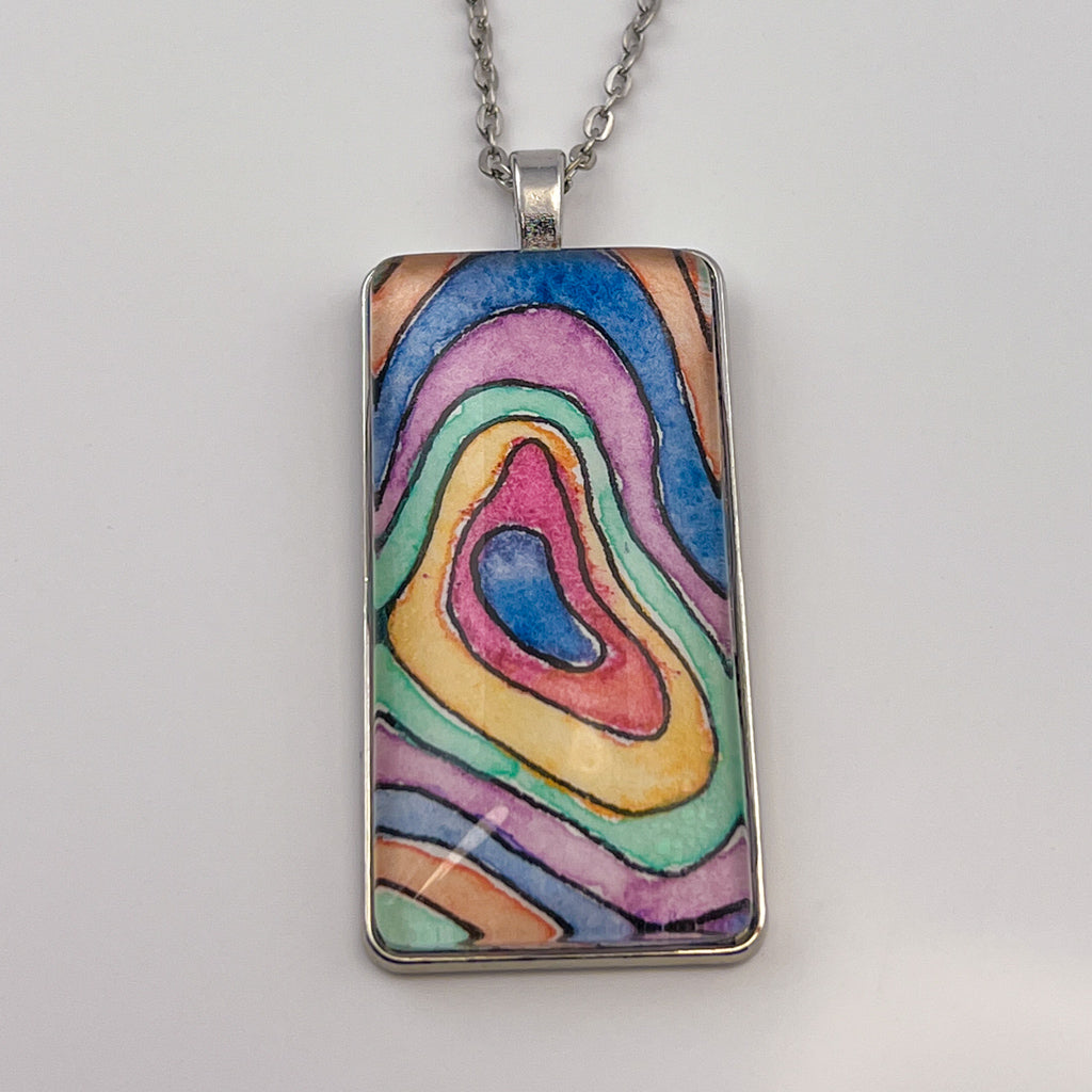 Hand-painted watercolor topographical map set behind a rectangular glass cabochon. 