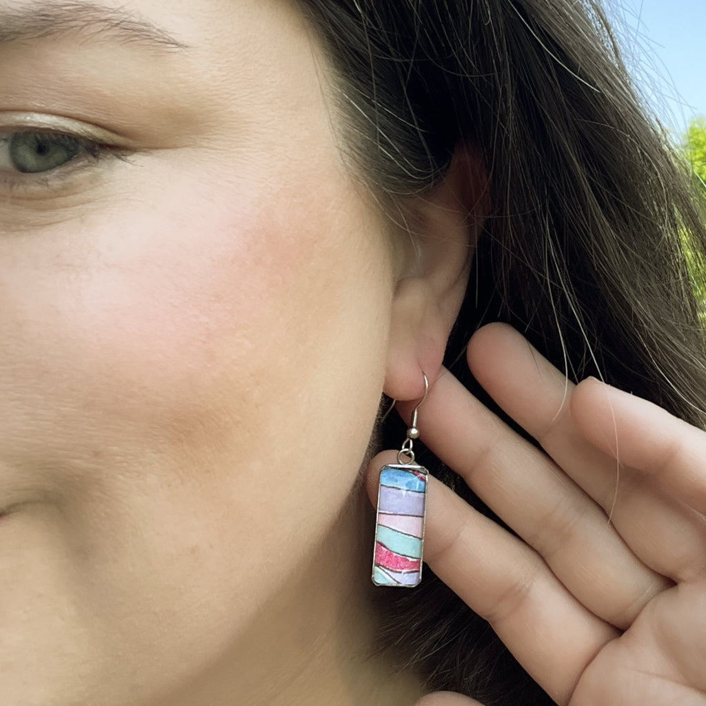 Melanie vertical drop earrings shown on model.