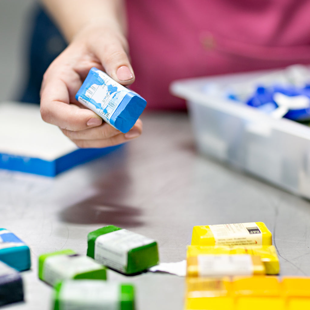 Closeup of sorting encaustic paint in the studio.