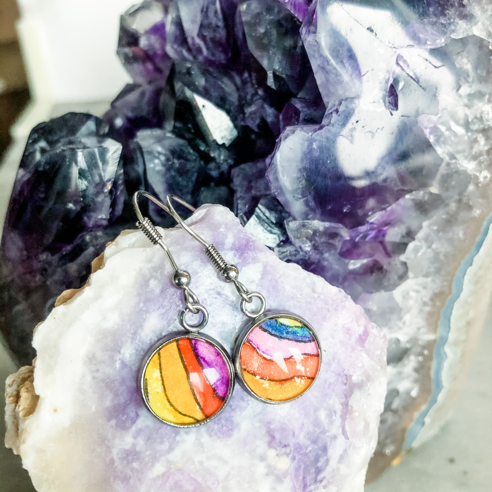 orange, red purple and blue drop earrings, displayed with amethyst and Mexican Grape Opal.