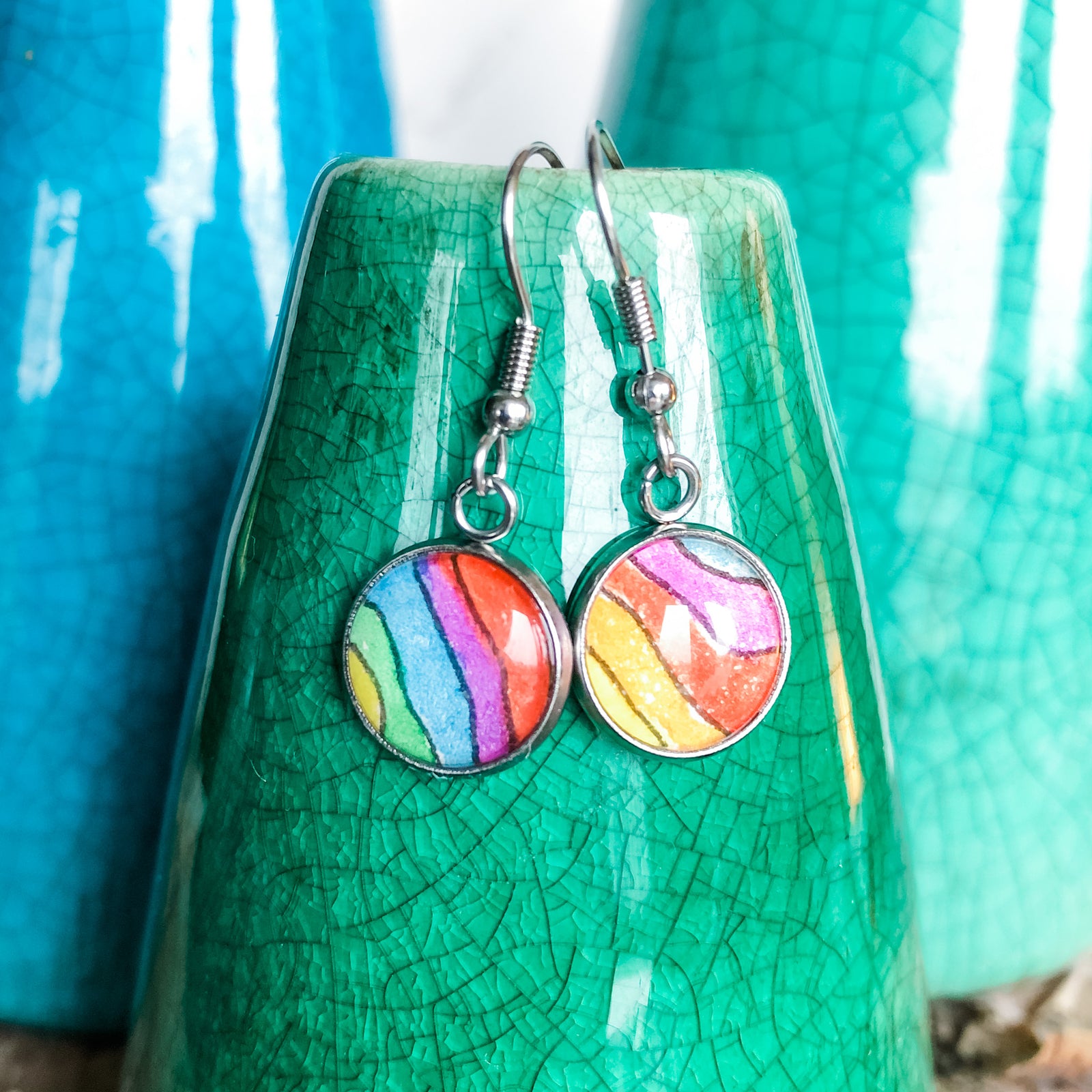 orange, red purple and blue drop earrings, displayed with amethyst and Mexican Grape Opal.